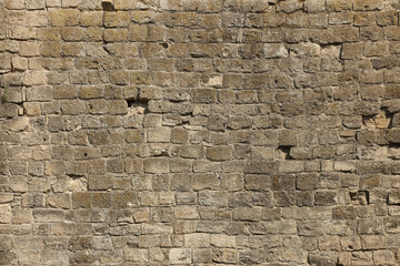 Very old brick stone wall of castle or fortress of 18th century. Full frame wall with obsolete...