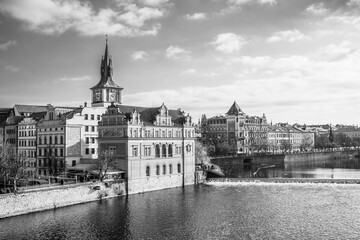 Fototapeta premium Bedrich Smetana Museum at Vltava River. Smetana embankment in Prague, Czechia. Black and white photography.
