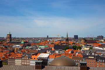 The Round Tower (Danish: Rundetaarn) and the Church of the Holy Spirit (Danish: Helligåndskirken). Aerial view of downtown of Copenhagen from the observation deck of Christiansborg Slot Palace.