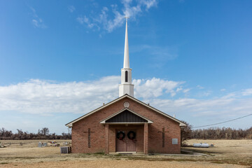 Simple red brick church with local cemetery in deep rural Mississippi - 700165867