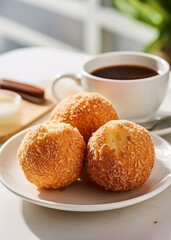 Three Brazilian cheese bread balls and coffee on the table, close-up