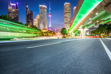 Empty asphalt and city buildings landscape at night in Shanghai