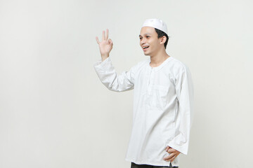 happy asian muslim man give ok hand gesture. People religious Islam lifestyle concept. celebration Ramadan and ied Mubarak. on isolated background.