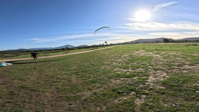 Powered paragliding- paramotor take off with powered paraglider two-stroke engine and paragliding wing froma  field airplane