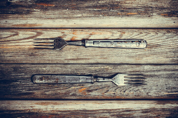 Vintage fork on wooden background