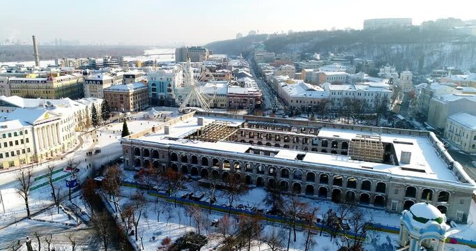 Aerial view of old residential buildings covered with snow. Podol Kontraktovaya Square in Kyiv Ukraine 2022