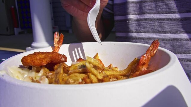 Eating shrimps, with french fries and mayonnaise