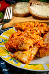 Fish in Greek kind with vegetables and tomato sauce.