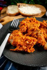 Fish in Greek kind with vegetables and tomato sauce.