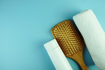 Shampoo bottles, combs and towels Body cleaning equipment on blue background