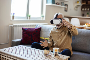 Happy man, interactive and game with vr glasses in home for fun, playing or adventure online in...