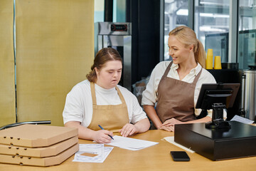 young woman with mental disorder writing order near positive administrator and pizza boxes in cafe