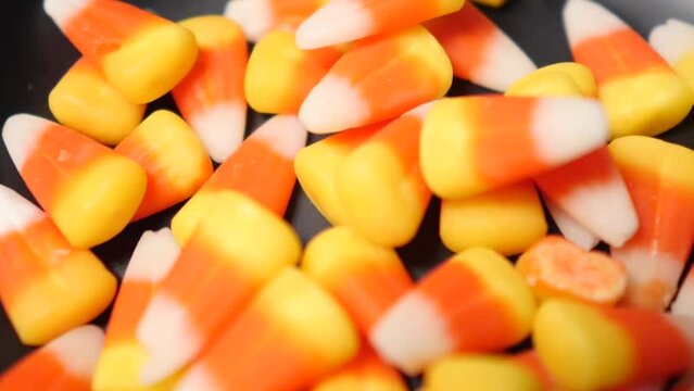 Candy Corn falling into a bowl