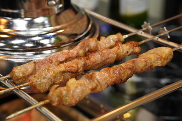 Grilled lamb skewers grilled over charcoal fire
