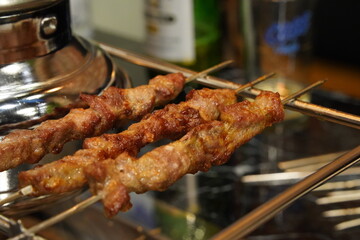Grilled lamb skewers grilled over charcoal fire
