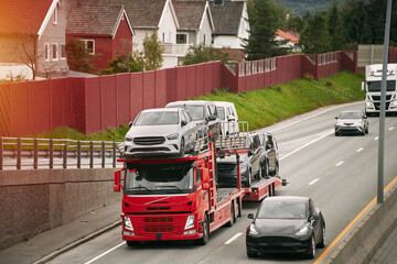 Hydraulic trailer with new cars and SUVs for the car market. The truck provides delivery and...