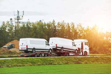 Roadside assistance transports a car with a breakdown on the road. Rollback tow truck. A tow truck...