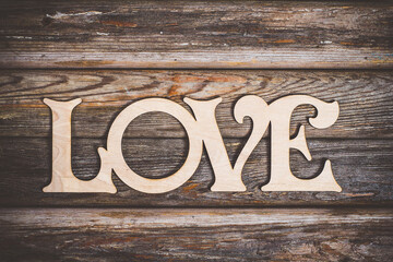 The inscription of love with wooden letters on the table in the style of Provence