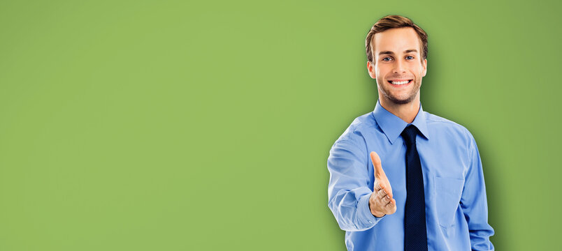 Businessman giving hand for handshake, isolated green background. Success in business, wellcome ad concept. Portrait of man in blue confident clothing. Copy space.