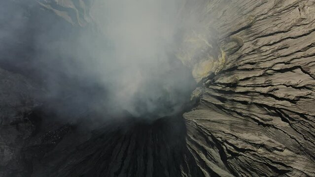 Drone flight through creater of Bromo volcano in east java, Indonesia on a beautiful sunny day