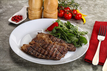 Grilled chuck roll steak with arugula