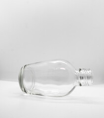 Empty bottle glass lying on white background with copy space for text.