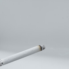 Cigarette in ashtray on white background, smoking concept