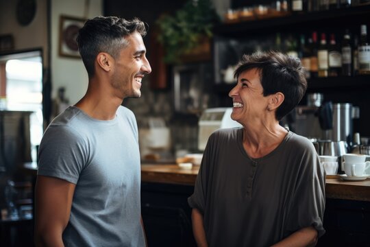 cene in a coffe shop a white mature woman with short grey hair having a conversation with a shaved young man with a very short black hair 