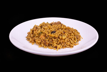 Sri Lankan biryani on a white plate against a black background