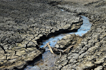 Drought dry earth soil cracks drying river - 700242055