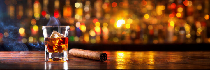 Whiskey with cigar on old wooden table and bar background. - obrazy, fototapety, plakaty