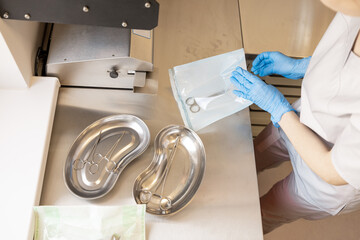 Process of sterilization and packaging of surgical instruments in sterilization of clinic, view...