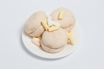 Marshmallows of different colors on a white background