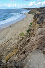 Wide sandy beach where people walk during a storm, Pacific Ocean, Malibu area
