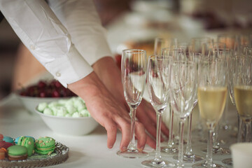 the arranging hand of empty glasses. Party and holiday celebration concept. Many glasses of...