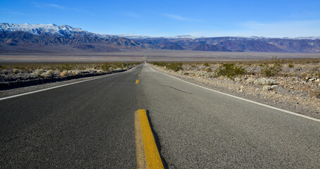 Straight Road in the California desert, going into the mountains near Death Valley National Park