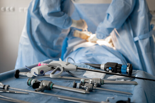 Surgery treatment in progress, close-up on medical tools and surgeons operating behind