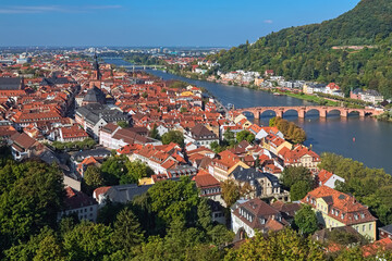 Heidelberg, Germany. High angle view over the Heidelberg Old Town with Church of the Holy Spirit and Old Bridge (Karl Theodor Bridge) across the Neckar river. - 700257456