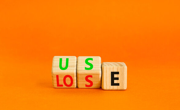 You use or lose it symbol. Concept word Use or lose on wooden cubes. Beautiful orange table orange background. Business and you use or lose it concept. Copy space.