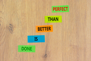 Done is better than perfect symbol. Concept words Done is better than perfect on colored paper. Beautiful wooden background. Business, done is better than perfect concept. Copy space.