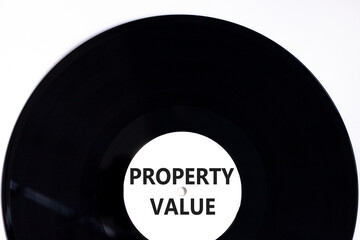 Property value symbol. Concept words Property value on beautiful black vinyl disk. Beautiful white table white background. Business property value concept. Copy space.