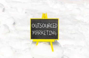 Outsourced marketing symbol. Concept words Outsourced marketing on beautiful black chalk...
