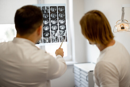 Man on medical appointment with urologist, doctor shows an X-ray of the patient's pelvis. Concept of men's health
