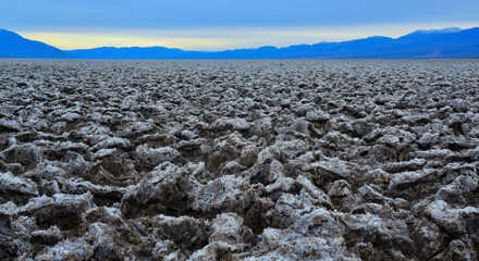 Death Valley National Park, Salt with clay, California. Smooth salt valley with cracked and swollen...