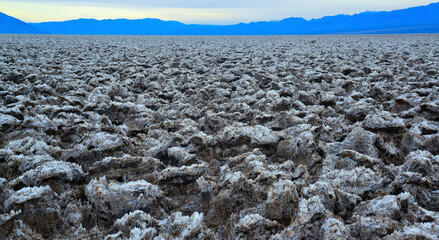 Death Valley National Park, Salt with clay, California. Smooth salt valley with cracked and swollen...
