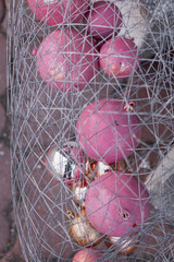Kyiv, Ukraine - December 29, 2023: New Year's decorations lie near a cafe. pink Christmas balls, Christmas tree branches and garlands. the city was decorated a little to set the mood.