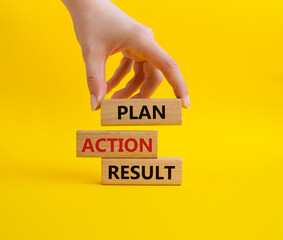 Plan Action Result symbol. Concept words Plan Action Result on wooden blocks. Businessman hand. Beautiful yellow background. Business concept and Plan Action Result. Copy space.