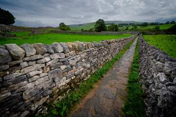 Pathway and stone walls in the Yorkshire Dales, England