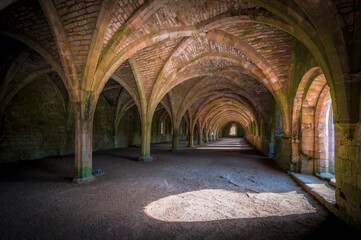 Interior gothic arches in the basement of an abandoned abbey