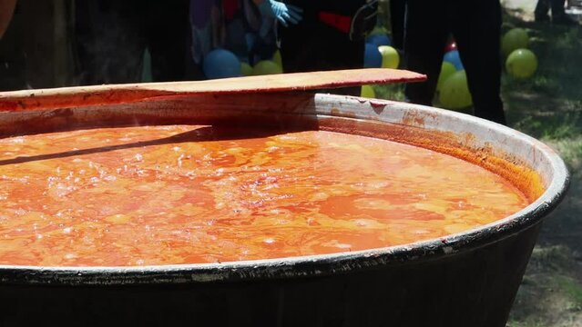 Tomato soup with pasta is a dish of Polish cuisine. Hot Zupa pomidorowa in a large cauldron at the field kitchen at a food fair. A popular soup made from grated tomatoes in their own juice.